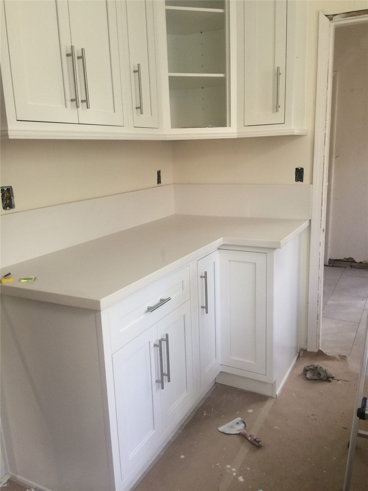 White custom cabinets and counters during installation